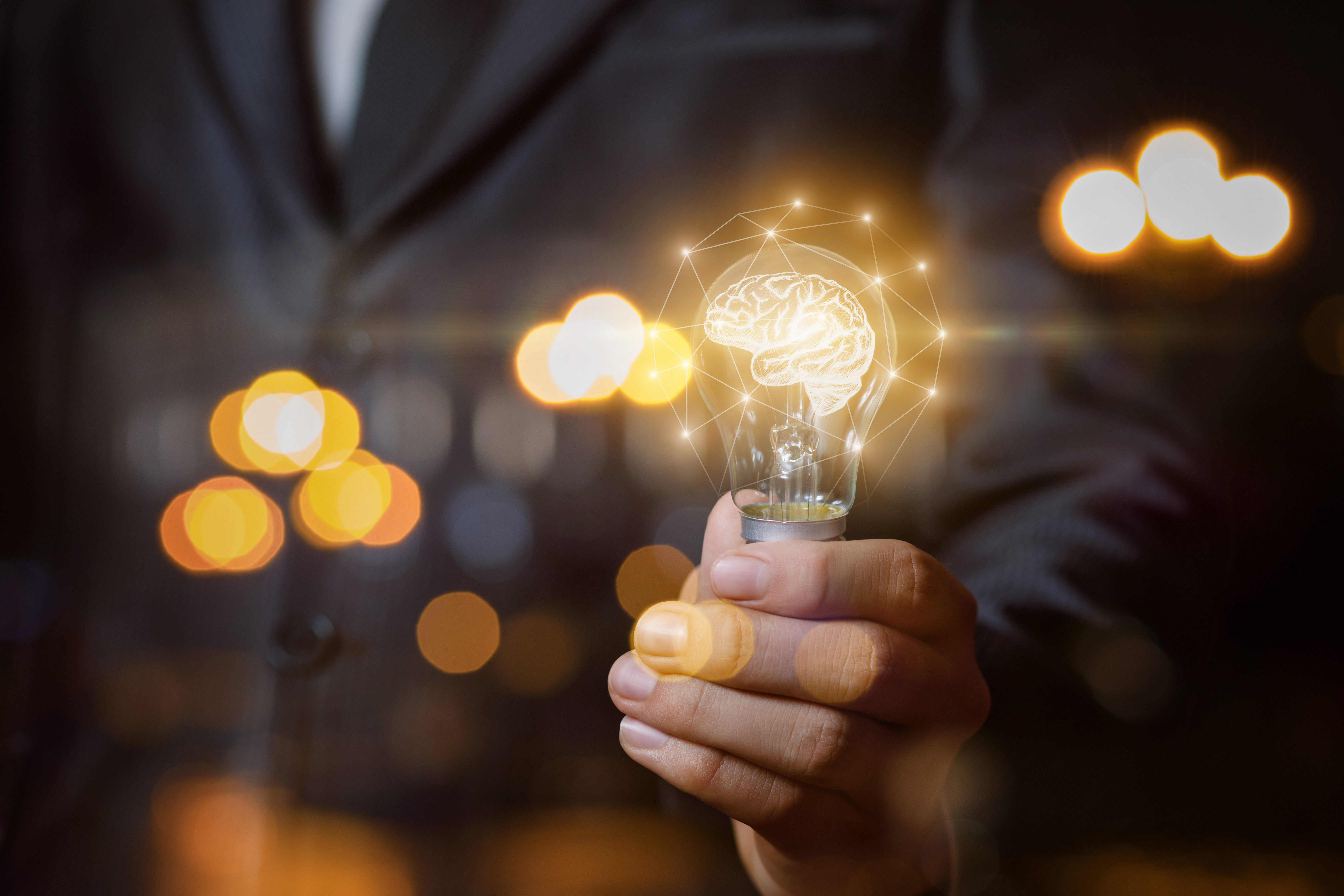 Light bulb with brain the hands of the businessman. stock photo